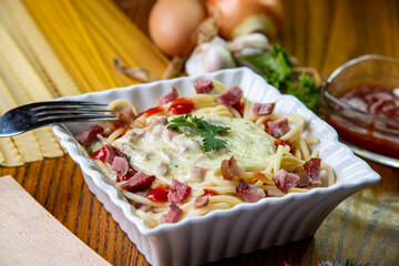 pasta with sauce, pasta carbonara on a wooden table