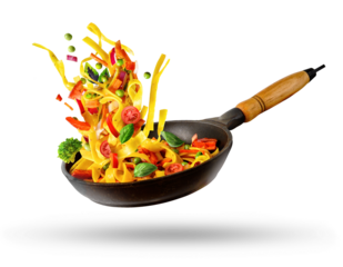 Cooking Italian pasta with vegetables flying over a hot frying pan isolated in white.