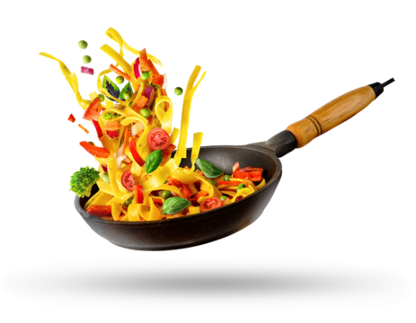Cooking Italian pasta with vegetables flying over a hot frying pan isolated in white.