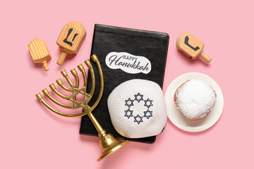 Hanukkah composition with Torah, kipa, menorah and donut on pink background