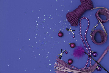 Sex toys with Christmas balls on violet background