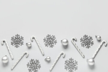 Beautiful snowflakes with Christmas balls and candy canes on grey background