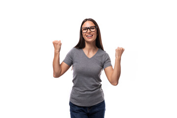 young promoter woman in glasses dressed in a gray t-shirt on a white background with copy space