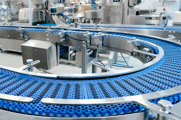 Empty modern conveyor belt of production line, part of industrial equipment in factory plant....