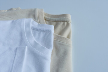 Close-up of a white and beige cotton T-shirt on a white background