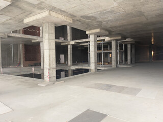 Interior of a modern office building with concrete walls and floor. Unfinished renovation.