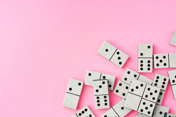 Domino tiles on pink background studio shot