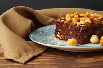 Brownie cake with chocolate and hazelnuts on plate