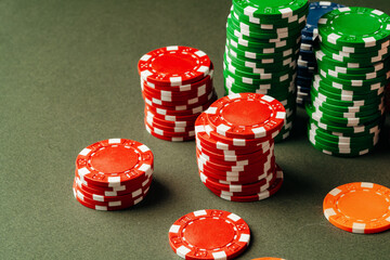 Lots of poker chips on green background