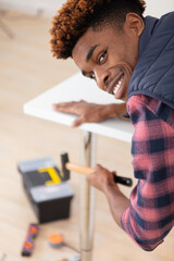 young handsome carpenter in the carpentry workshop