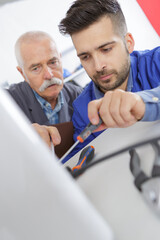 apprentice working on machine part