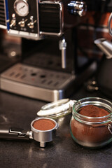 Morning coffee. Close up photo with a vintage coffee machine preparing an espresso drink in a white ceramic pot. Working from home environment in an industrial kitchen decor.