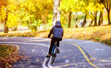 Poster Cyclist ride on the bike path in the city Park  © licvin