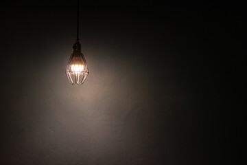 Light bulb warm light shade on dark background, concept of creativity and innovation. - obrazy, fototapety, plakaty