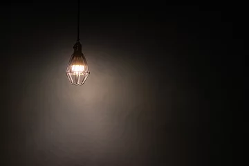 Foto op Plexiglas Light bulb warm light shade on dark background, concept of creativity and innovation. © Chalearmrat