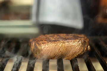 Grilled meat steak on stainless grill with flaming, Food and cuisine concept.