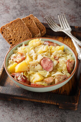 German Jager Kohl, hunter's cabbage with Sausage, Bacon and Potatoes close-up in a bowl on the...
