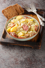 Jagerkohl German Hunter Cabbage Stew close-up in a bowl on the table. Vertical