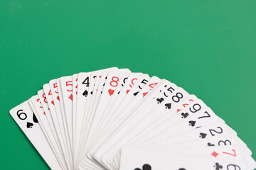 Playing cards. Gambling, bridge, poker concept. Sport equipment.Green background.