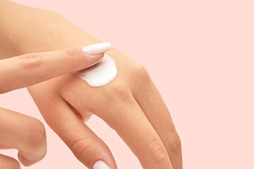 Woman  applying moisturizing hand cream, closeup. skincare