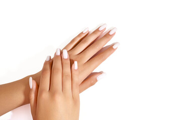 Close up of hands of young woman with long white manicure on nails isolated.