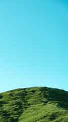 green hill and blue sky