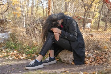 Caucasian young girl covering her face.