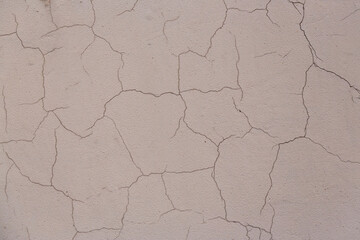 Old wall with cracked plaster. Weathered rough surface. Vintage texture is perfect for background and design.