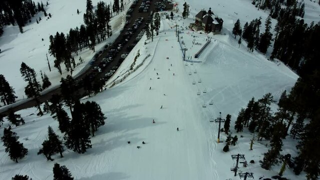 Ashland, Oregon, USA, Winter 2023.  Mt Ashland Ski Area.  Moving Backwards Up The Beginner Lift Sonnet With The Parking Lot And The Lodge Visible.