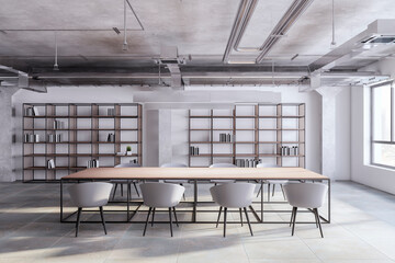 New loft meeting room interior with bookshelves, concrete flooring, furniture and panoramic window with city view and daylight. 3D Rendering.