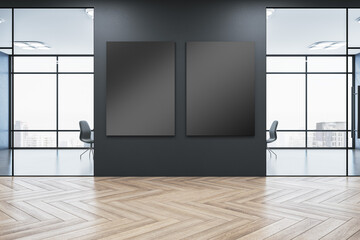 Modern gallery interior with empty mock up posters on black wall , windows with city view, reflections on wooden parquet flooring and daylight. 3D Rendering.