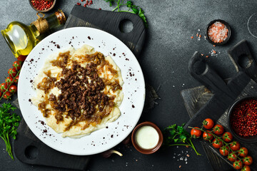 Dumplings with cracklings in a plate. Free space for text. Close up.