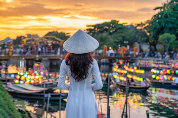 Asian woman wearing vietnam culture traditional at Hoi An ancient town, Vietnam. Hoi An is one of the most popular destinations in Vietnam  from Korea, Thailand, USA, Japan, China - obrazy, fototapety, plakaty