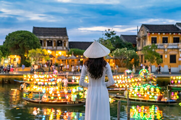 Asian woman wearing vietnam culture traditional at Hoi An ancient town, Vietnam. Hoi An is one of...