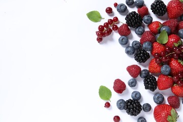 Many different fresh berries and mint leaves on white background, flat lay. Space for text