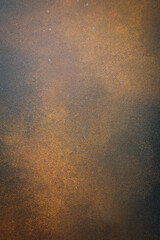 Dark brown grunge background with imitation of rust on metal. Free space for text. Vertical photo. Top view.