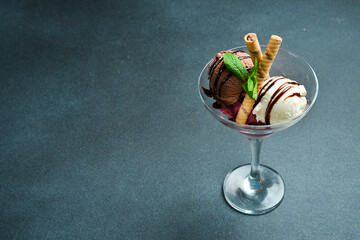 Chocolate ice cream with fruit in a glass. Free space for text. Close up.