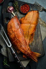 Smoked fish red sea bass. Sea bass closeup. Delicious seafood for proper nutrition. On a black...