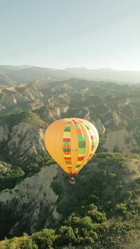 hot air balloon over the mountains during sunrise vertical video