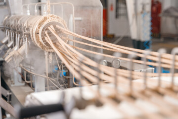 Food extruder machine for crunchy bread sticks on conveyor at manufacture, manufacturing snack line