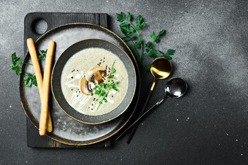 Mushroom cream soup of champignons with cream. In a bowl. Healthy food concept. Close up.