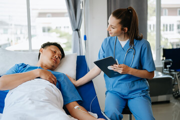 Obraz premium Friendly Female Head Nurse Making Rounds does Checkup on Patient Resting in Bed