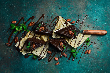 homemade chocolate brownies on a dark background. Sweets and chocolate. Top view.