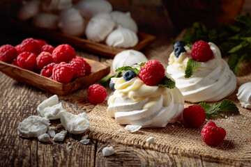 Dessert Pavlova with raspberries, blueberries and mint.