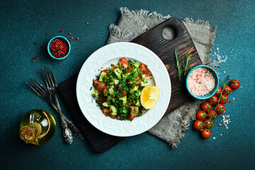 Fresh vegetable salad with olive oil and lemon. In a white plate. Free space for text.