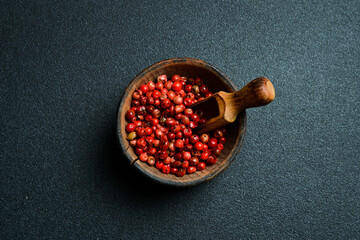 A bowl of red pepper peas. On a black background. Top view. Free space for text.