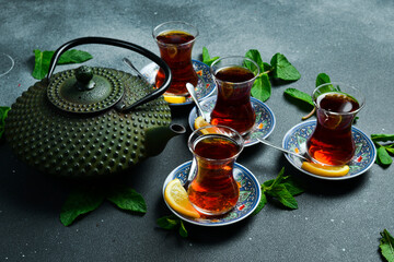 Tea ceremony. Azerbaijani traditional serving of tea. Black tea in a cast iron teapot. Top view.