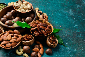 Assorted shelled nuts: walnuts, cashews, hazelnuts, Brazil nuts, almonds. Close up, macro. Assortment of shelled nuts. Side view. on the texture table.