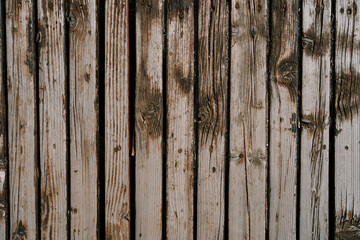 Texture of an old unpainted shabby wooden fence