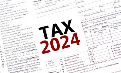 tax 2024 on white sticker with tax forms